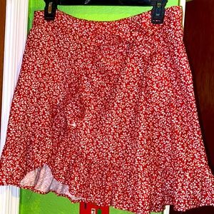 Red ruffle floral skirt with zipper in back and tie on side.
